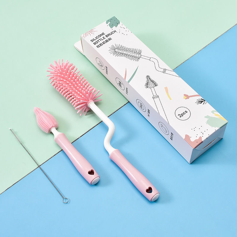 Pink bottle brush and cleaning tool set with packaging on a colorful background