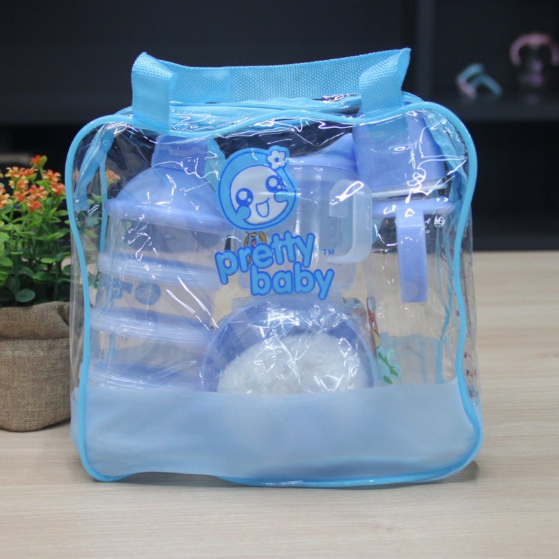 Clear blue baby bottle set in a transparent bag with 'pretty baby' branding on a wooden surface.