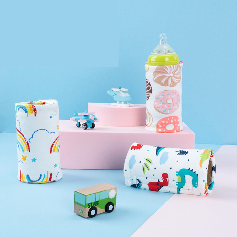 Colorful baby bottles and toys on a blue background